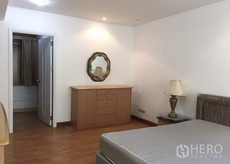 คอนโด ให้เช่าหรือขายในWatthana, Bangkok - มุมห้องนอนหลักพร้อมตู้ลิ้นชัก กระจกตกแต่ง และประตูเข้าห้องแต่งตัวแบบวอล์กอิน