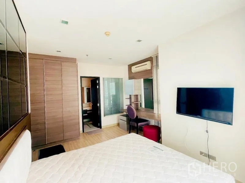 Condominium for rent - Master bedroom with wardrobe, work desk, air conditioner, and wall-mounted TV.