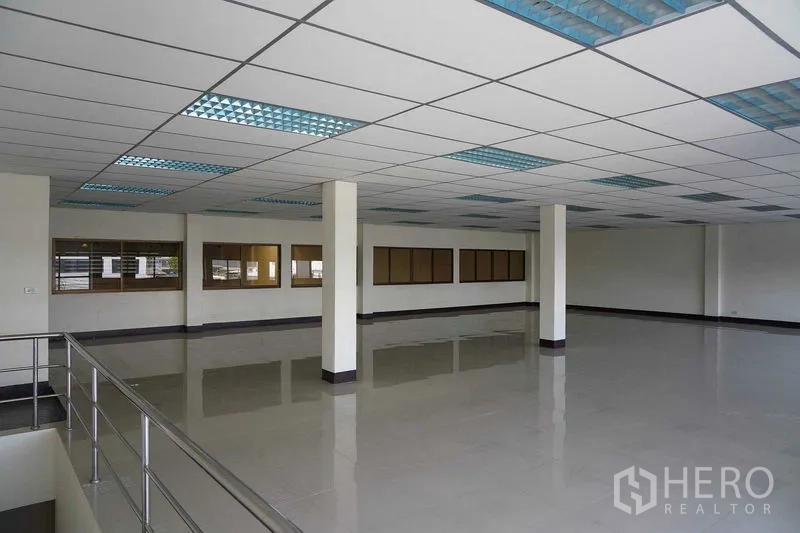 Factory for rent in Bang Sao Thong, Samut Prakan - Mezzanine office space with drop ceiling, bright lighting and railing.
