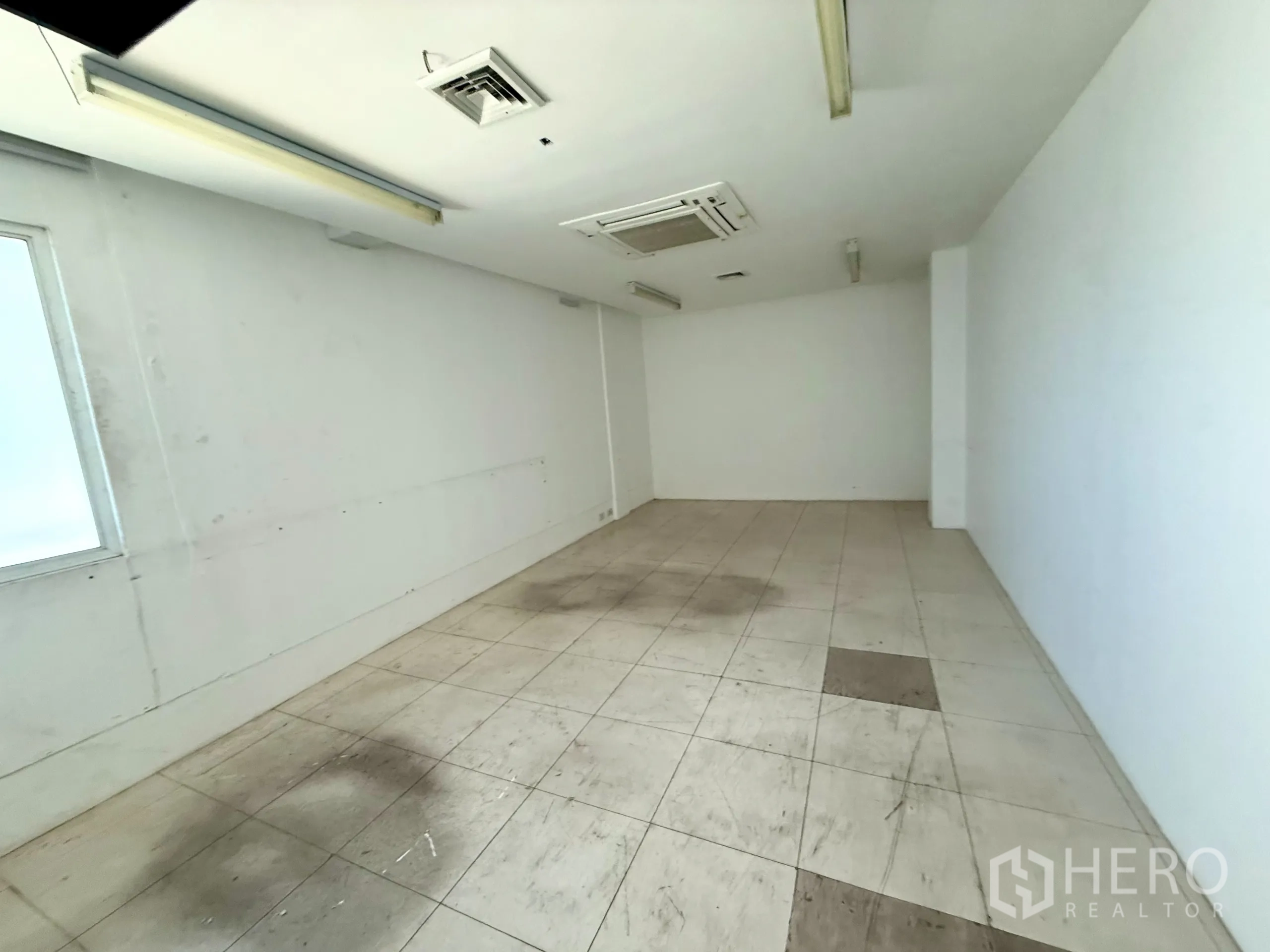 Office Space for rent in Bueng Kum, Bangkok - Partitioned office with wood-look flooring and blue windows.