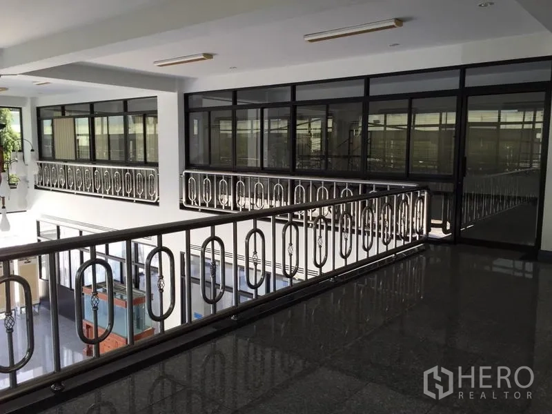 Standalone for rent in Bang Phli, Samut Prakan - Upper-floor corridor with stainless railings and glass-partitioned office rooms.