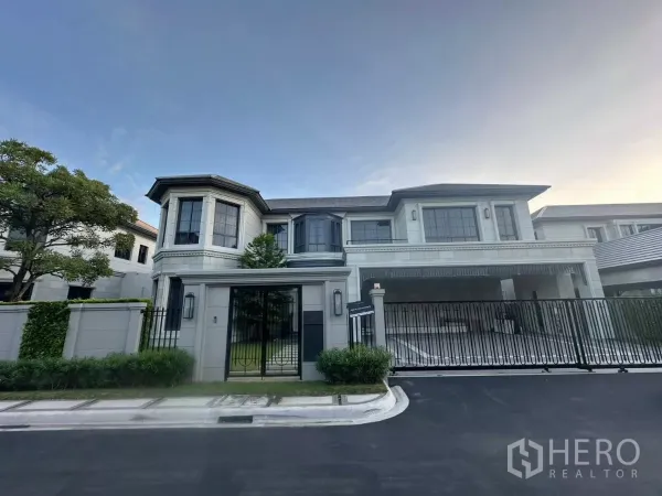 Detached House for rent or sale in Bang Kapi, Bangkok - Grand two-storey detached house with gated driveway and landscaped frontage in a luxury estate.