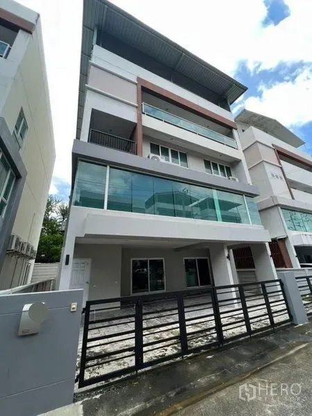 Home Office for rent or sale in Bang Phli, Samut Prakan - Modern multi-storey home office facade with glass balconies and gated parking.