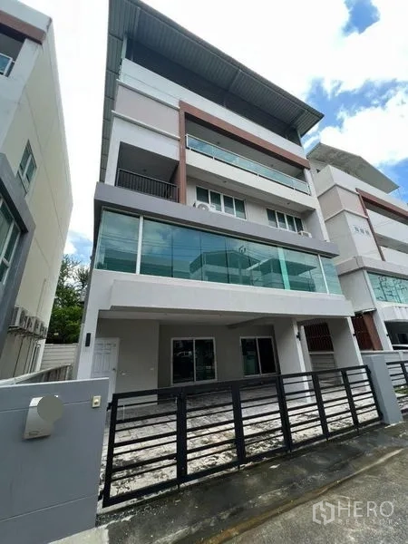 Home Office for rent or sale in Bang Phli, Samut Prakan - Modern multi-storey home office facade with glass balconies and gated parking.