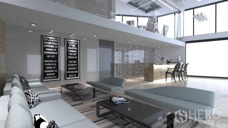 Shophouse for rent in Khlong San, Bangkok - Open-plan lounge with mezzanine office, large windows and a reception counter.