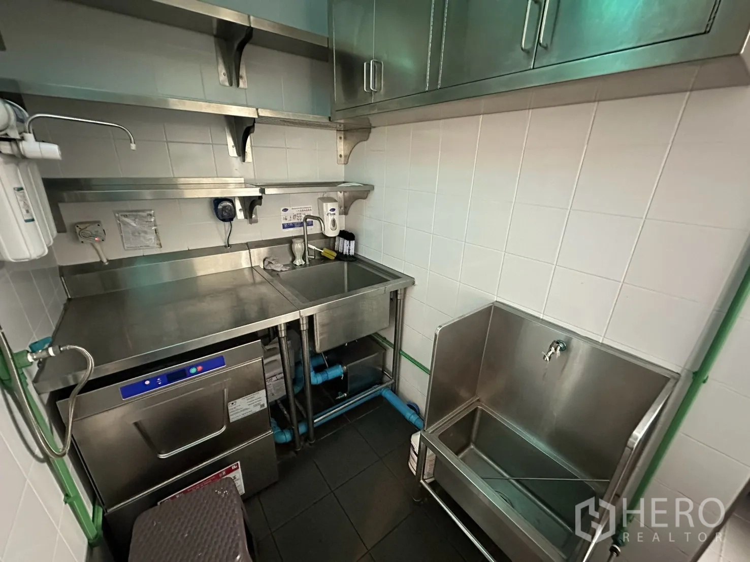 Detached House for rent in Watthana, Bangkok - Dishwashing area with stainless sink, shelves, and equipment.