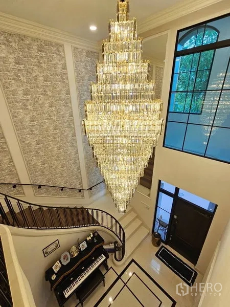 Detached House for rent or sale in Saphan Sung, Bangkok - Top-down view of a dramatic chandelier above the foyer and piano.