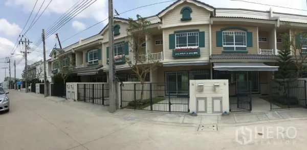 Townhouse for rent in Bang Bo, Samut Prakan - Row of modern townhouses along a quiet residential street with fenced front yards.