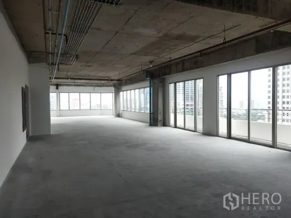 Office Space for rent in Watthana, Bangkok - Spacious bare-shell office floor with large windows and Bangkok skyline views.