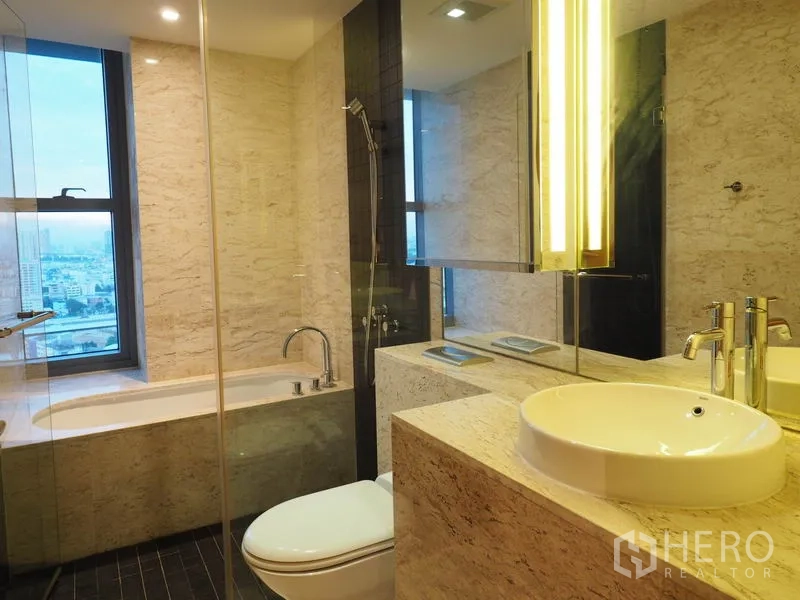 Condominium for rent in Yan Nawa, Bangkok - Elegant bathroom with bathtub, glass shower, stone vanity and window view.