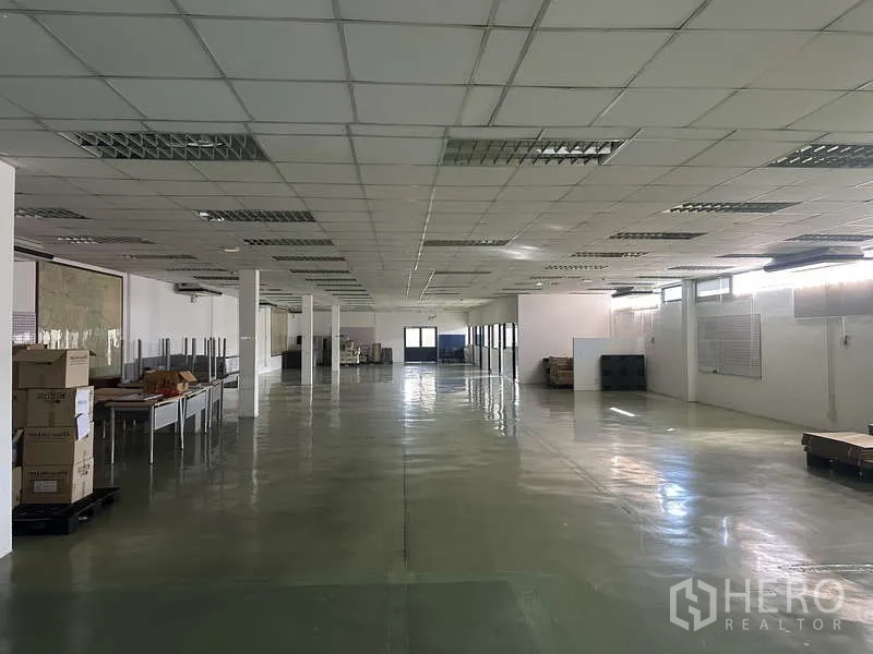Warehouse for rent in Khlong Sam Wa, Bangkok - Expansive open‑plan warehouse floor with drop ceiling, polished surface and support columns.