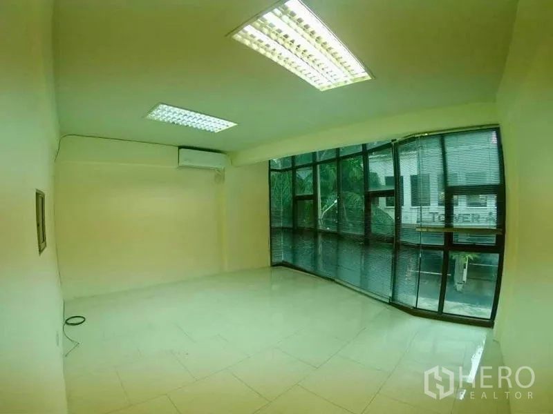 Office Space for rent in Khlong Toei, Bangkok - Corner office with large bay windows, blinds, bright ceiling lights and AC.