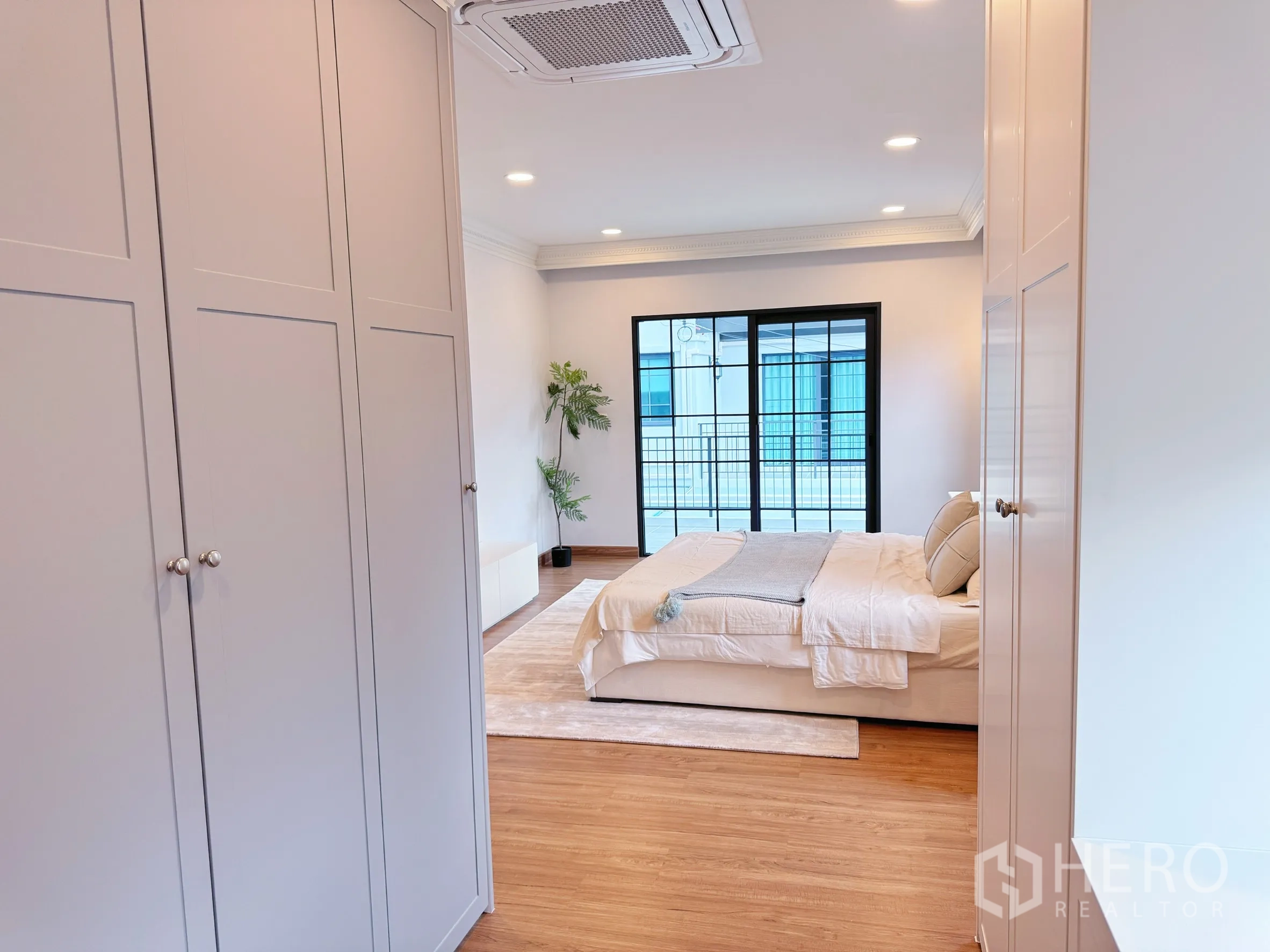 Detached House for rent in Bang Phli, Samut Prakan - View from closet toward bedroom with wardrobes on both sides.