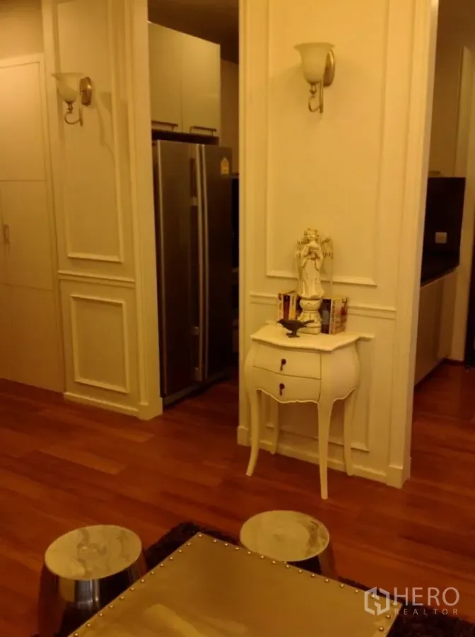 Condominium for rent in Watthana, Bangkok - Classic-style entry with paneled walls, wall sconces, and a stainless double-door fridge beside the kitchen.