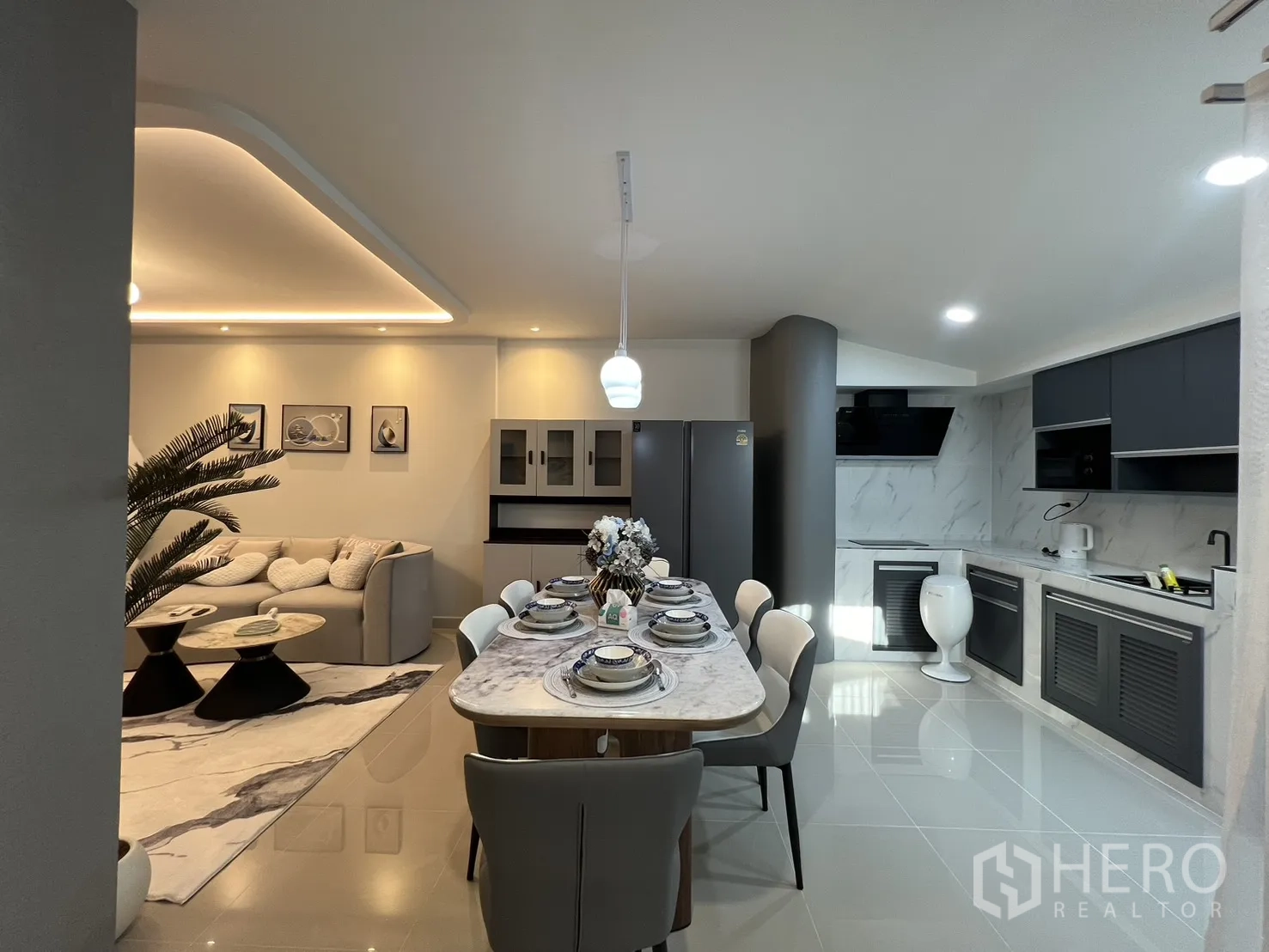 Townhouse for rent in Bang Phli, Samut Prakan - View from living to kitchen showcasing sleek cabinetry and pendant lighting.