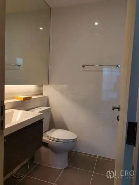 Detached House for rent in Bang Phli, Samut Prakan - Bright bathroom with floating vanity, mirror cabinet and tiled walls.