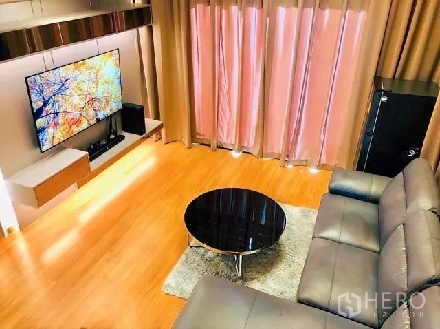 Detached House for sale in Suan Luang, Bangkok - Upper‑floor family lounge featuring leather sofa, TV, wood floors, and warm lighting.