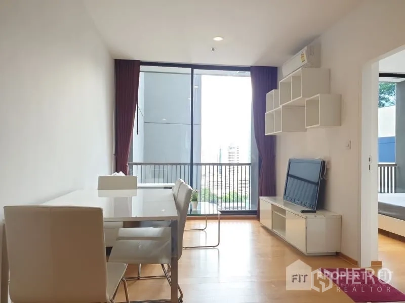 公寓 出租或出售在Bang Rak, Bangkok - 采光充足的客餐厅，落地窗连接阳台，墙面收纳与电视柜。