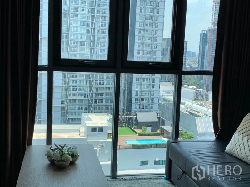 Condominium for rent or sale in Phra Khanong, Bangkok - City skyline and swimming pool view from the living room windows.