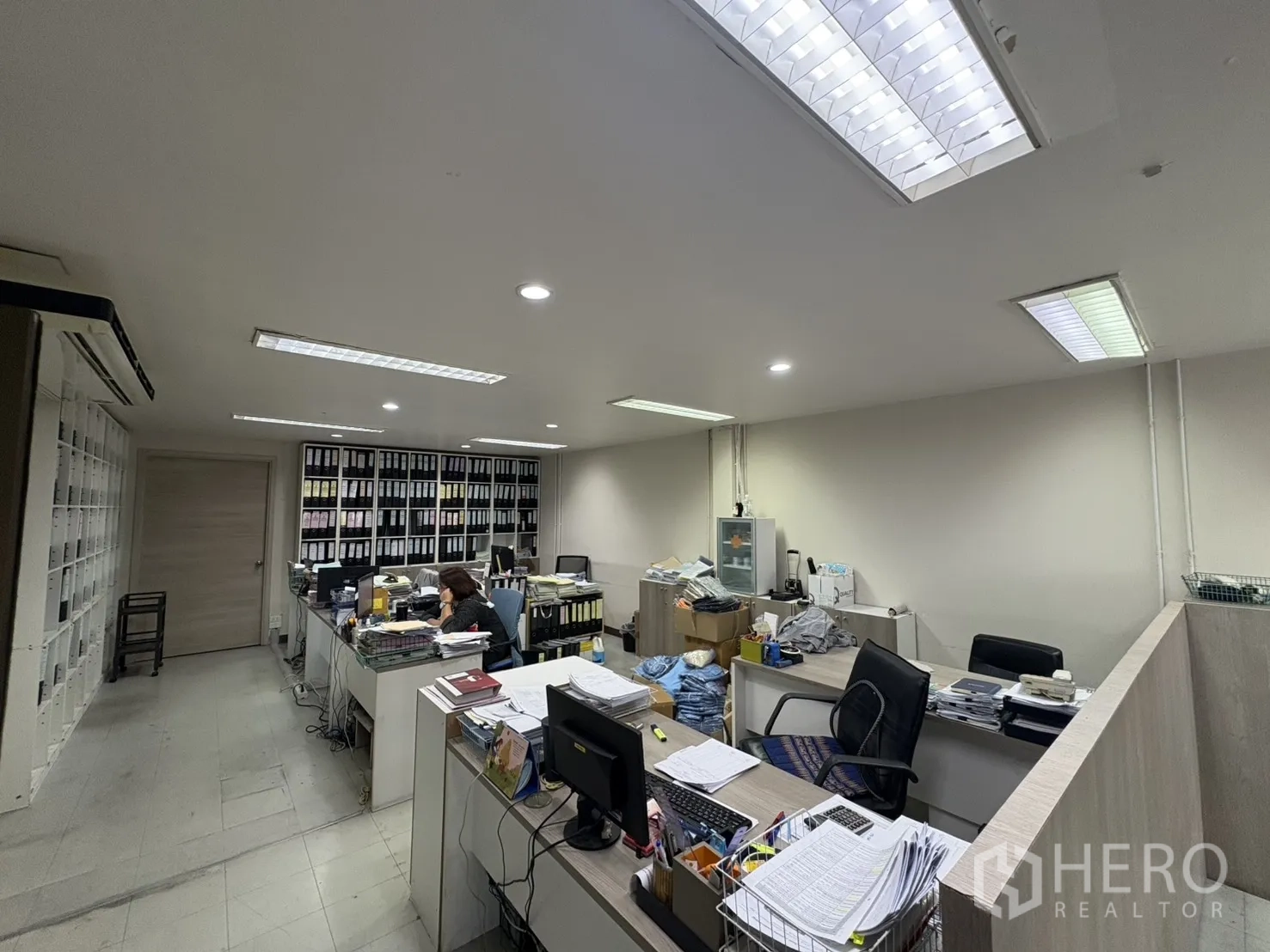 Factory for sale in Khlong Toei, Bangkok - Administrative office with desks, filing shelves and fluorescent lights