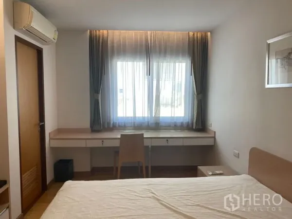 คอนโด ให้เช่าหรือขายในKhlong Toei, Bangkok - ห้องนอนพร้อมโต๊ะทำงานยาวใต้หน้าต่างบานใหญ่และเครื่องปรับอากาศ