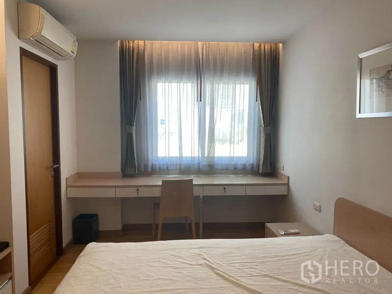 คอนโด ให้เช่าหรือขายในKhlong Toei, Bangkok - ห้องนอนพร้อมโต๊ะทำงานยาวใต้หน้าต่างบานใหญ่และเครื่องปรับอากาศ