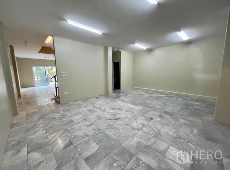 Townhouse for rent - Open living area with marble-look tiles facing the front gate.