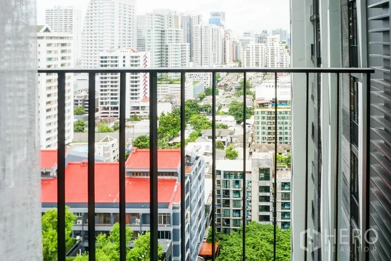 Condominium for sale in Watthana, Bangkok - High-floor balcony view over Sukhumvit with skyline and greenery.