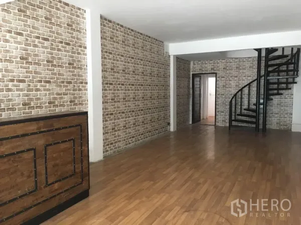 อาคารพาณิชย์ ให้เช่าในKhlong Toei, Bangkok - พื้นที่ภายในอาคารพาณิชย์แบบโอเพ่นสเปซ ผนังลายอิฐ พื้นไม้ เคาน์เตอร์ไม้ และบันไดเวียนสีดำ