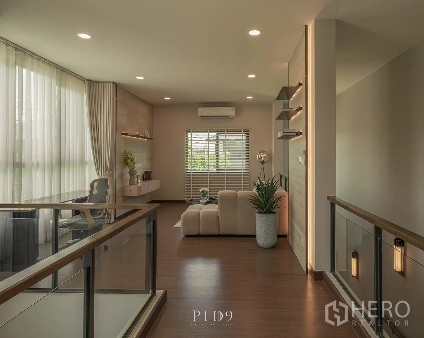 Detached House for rent in Bang Phli, Samut Prakan - Hallway view to seating area with desk, glass rails and downlights.