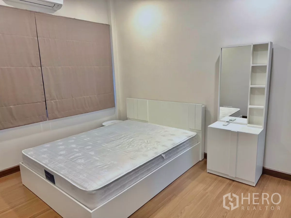 Detached House for rent in Bang Phli, Samut Prakan - Cozy bedroom with white bed, vanity and wood flooring, air-conditioned.