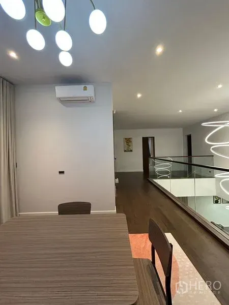 Detached House for rent in Bang Kapi, Bangkok - Upper landing with dining nook, wood floor and contemporary pendant lights