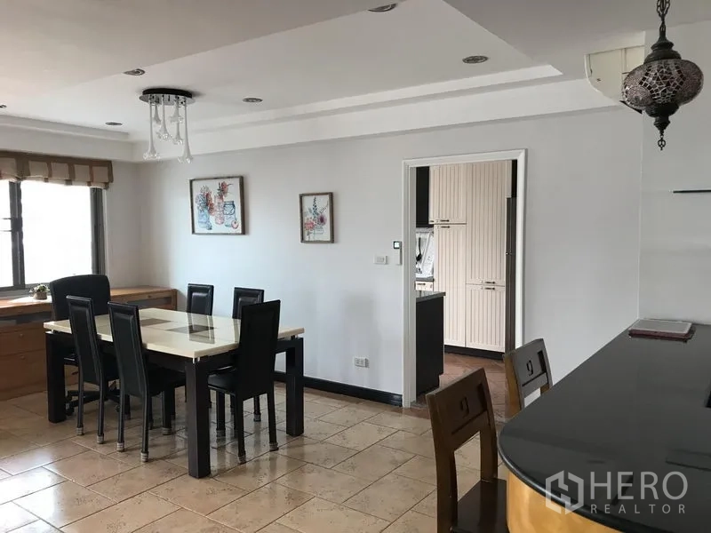 Condominium for rent in Watthana, Bangkok - Bright dining area with six-seat table, tiled floors and entry to a separate kitchen at Royal Castle, Phrom Phong.