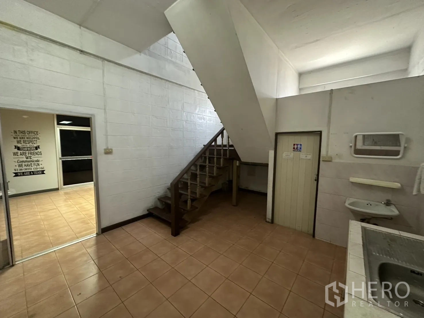 Warehouse for rent in Bang Na, Bangkok - Ground-floor common area with stairs beside pantry and office entry.
