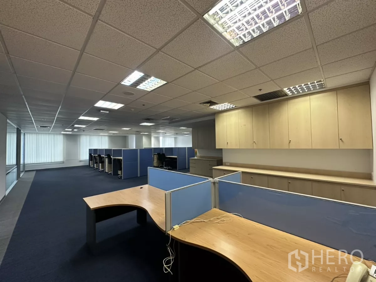 Office Space for rent in Watthana, Bangkok - Wide open office floor with partitioned desks, overhead cabinets and ample lighting.