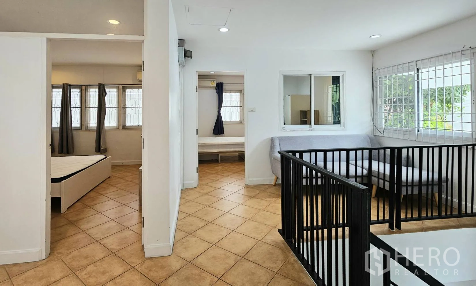 Detached House for rent in Saphan Sung, Bangkok - Bright upstairs hallway and landing with black railing leading to multiple bedrooms.