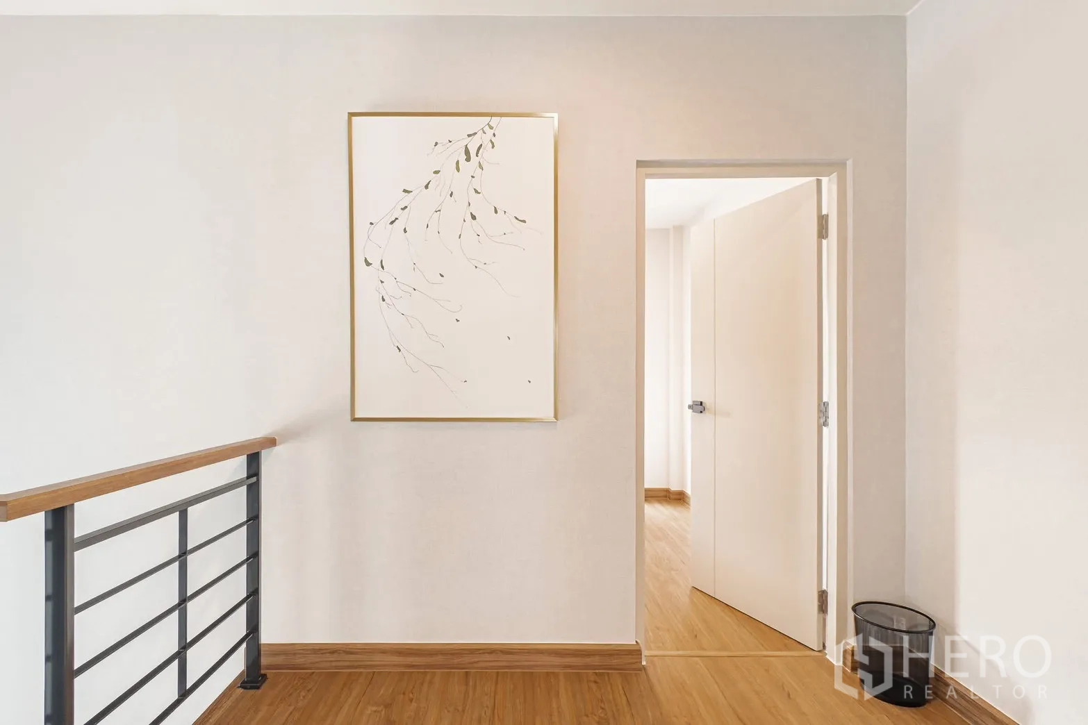 Detached House for rent in Bang Phli, Samut Prakan - Upstairs landing with minimalist artwork, doorway, and metal railing.