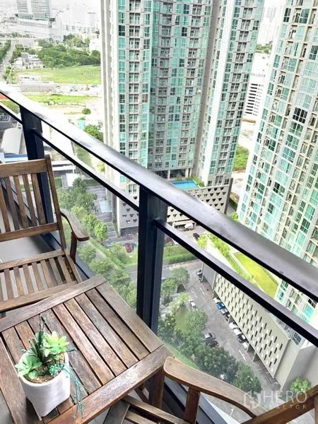 Condominium for rent or sale in Huai Khwang, Bangkok - High-rise balcony view down to a courtyard and neighboring towers.