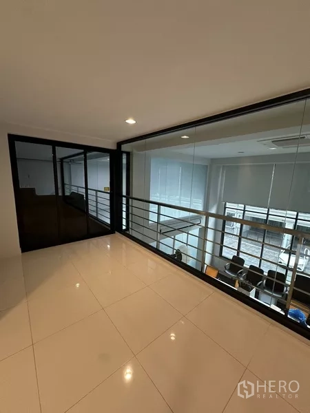 Home Office for rent - Glass-lined mezzanine corridor with railing overlooking the meeting room.