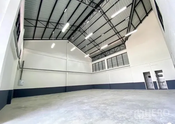 Warehouse for rent in Lat Lum Kaeo, Pathum Thani - Spacious warehouse hall with high steel‑truss ceiling, LED lighting and concrete floor.