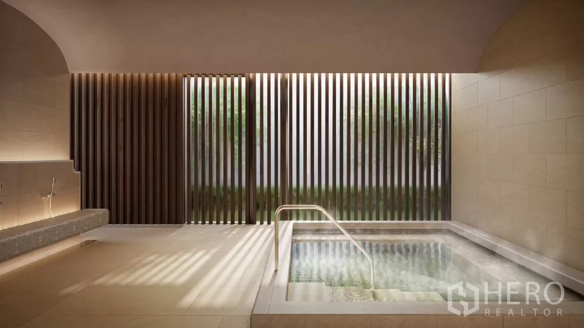 Apartment for rent in Khlong Toei, Bangkok - Indoor onsen-style hot tub with stone tiles and slatted wood screen allowing soft natural light.