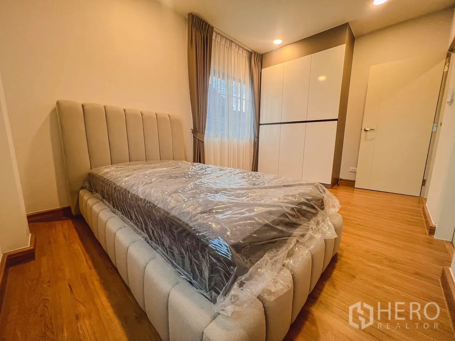 独栋房屋 for rent in Bang Phli, Samut Prakan - 卧室角度展示软包床与大衣柜，窗边配帘幕。
