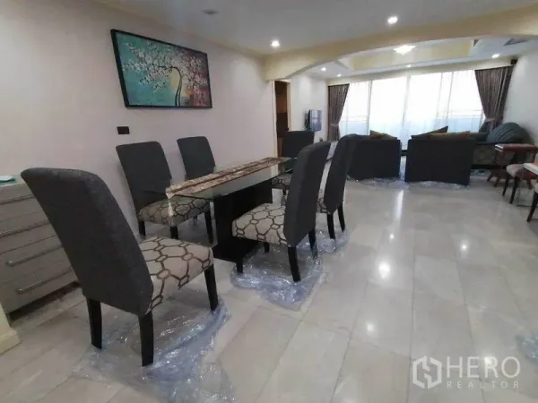 Condominium for rent in Watthana, Bangkok - Open-plan dining and living room with a six-seat table and large windows.