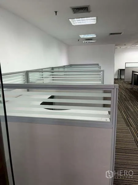 Office Space for rent - Additional cubicles along the corridor in the open office area.