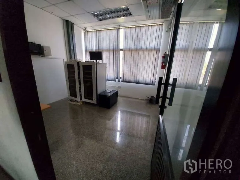 Warehouse for rent in Khlong Sam Wa, Bangkok - IT server room with equipment racks and window blinds.
