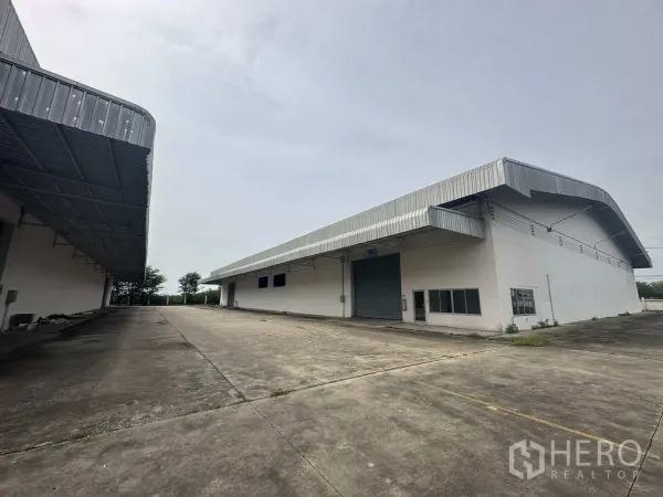 货栈 出租在Phra Nakhon Si Ayutthaya - 仓库立面配卷闸门、雨棚及充足回转空间。