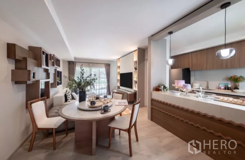 Townhouse for rent in Bang Phli, Samut Prakan - Open dining and kitchen space with warm wood cabinetry and island counter.