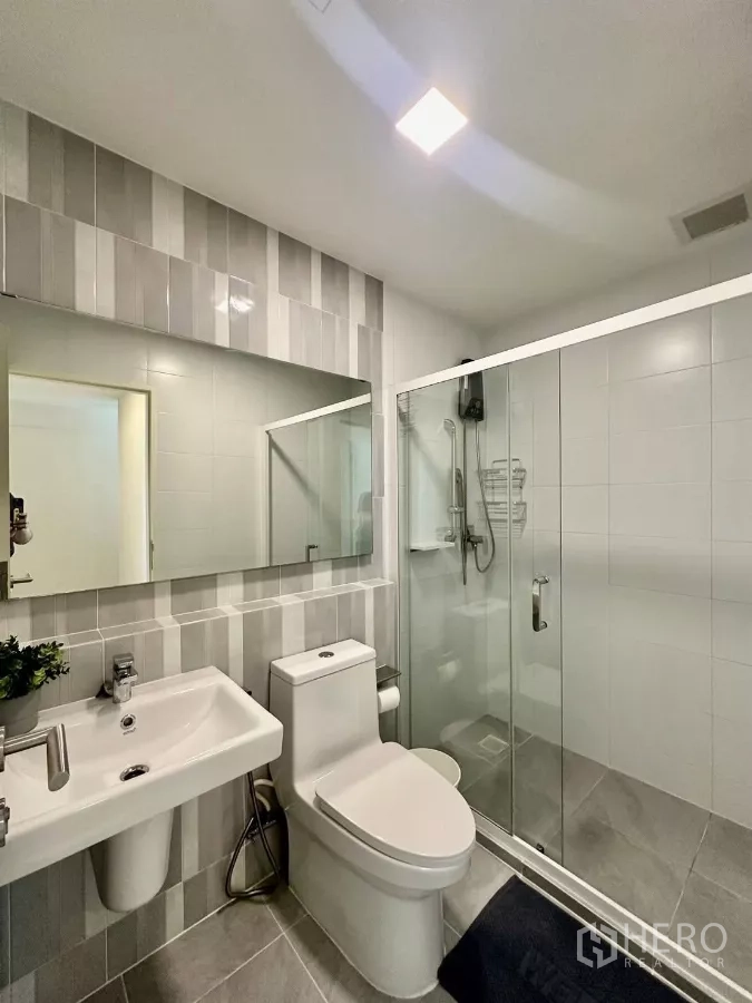 联排别墅 出租在Prawet, Bangkok - 后部封闭式泰式厨房与洗衣区，配洗衣机、水槽与储物。