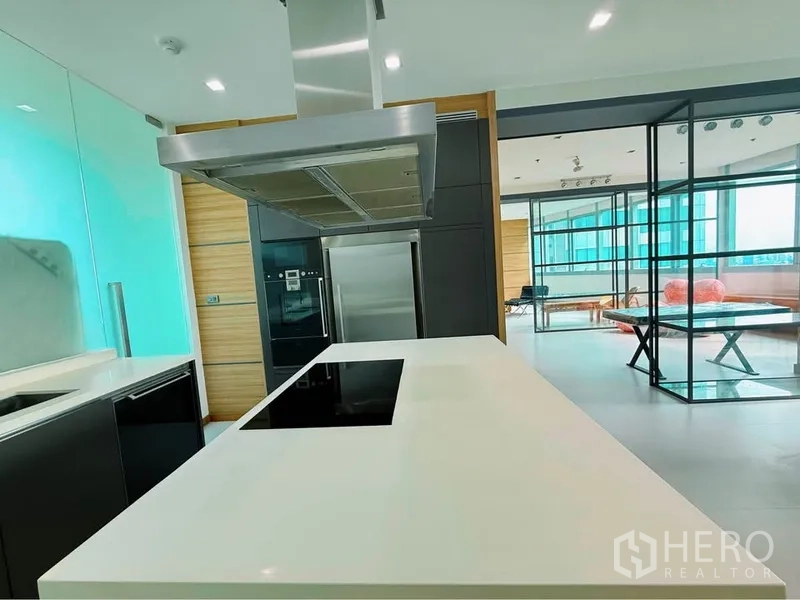 คอนโด ให้เช่าหรือขายในKhlong Toei, Bangkok - ครัวทันสมัย ไอแลนด์สีขาว เตาอินดักชัน ฮูดสเตนเลส และตู้เย็นสูง พร้อมผนังกระจก