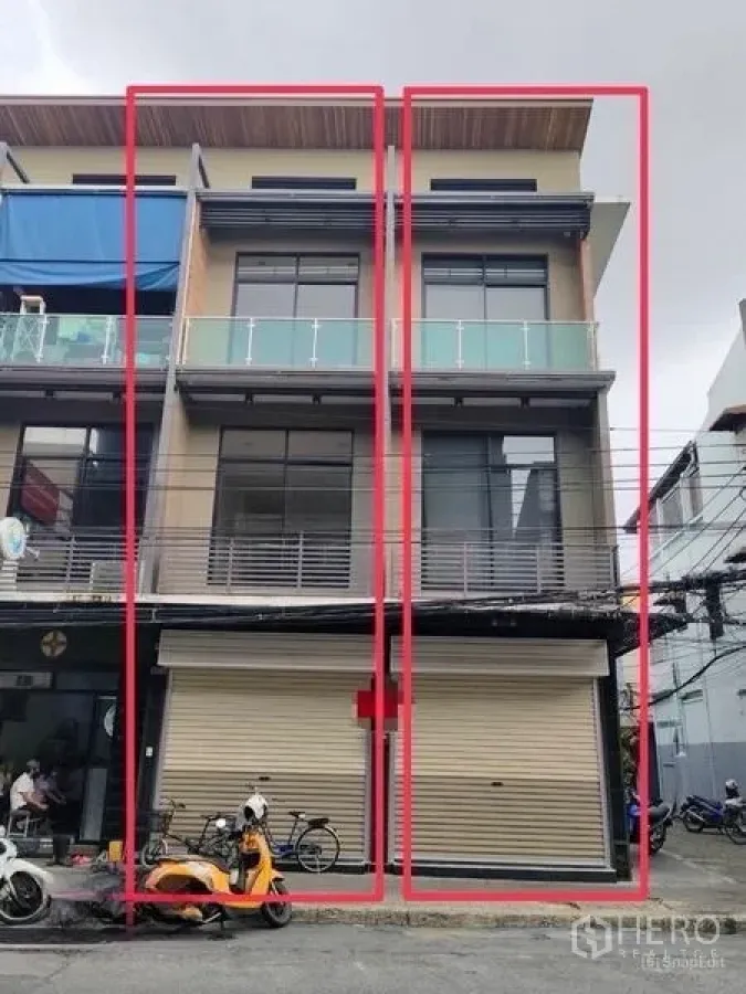 Shophouse for rent or sale in Pom Prap Sattru Phai, Bangkok - Exterior of three-storey twin shophouse units with balconies and roller shutters.
